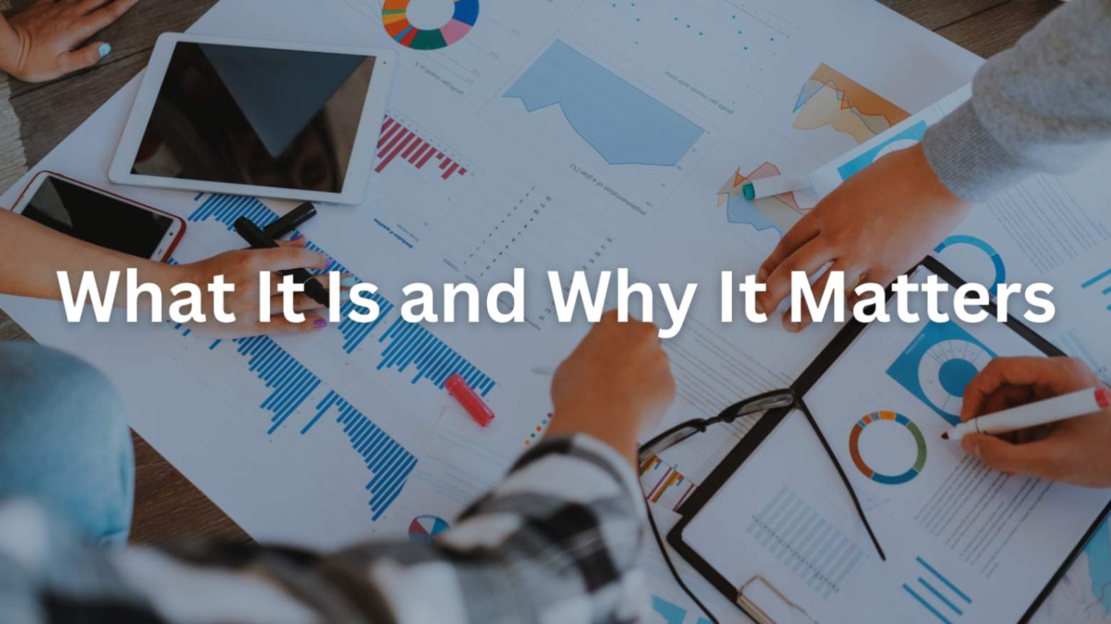 Detailed analysis of business documents and data charts spread on a table with digital devices.